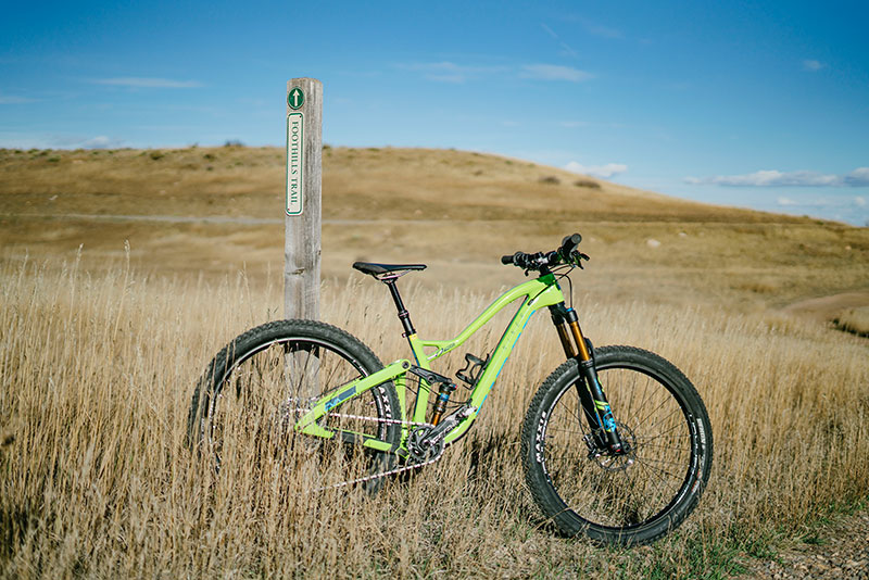 Mountain Bike leaning about trail post