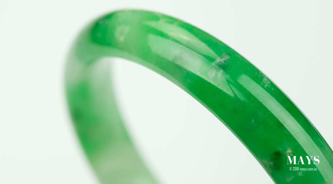 Uneven ditribution of colour on a dyed jade bangle