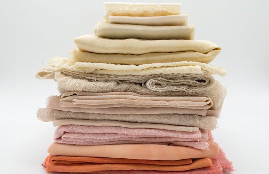 pile of orange pink and white stacked linens