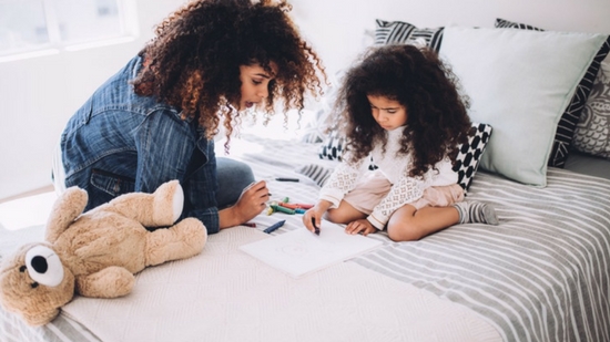 Mother and daughter on bed