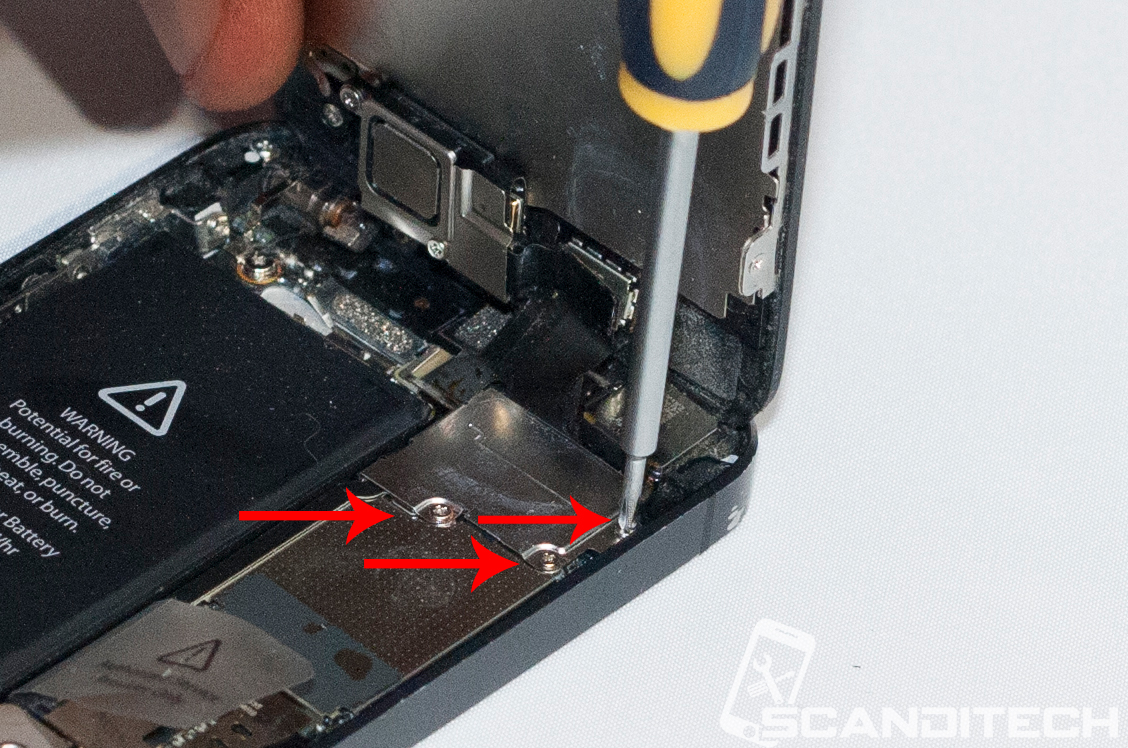 iPhone 5 battery replacement guide - Removing the metal cover screws.