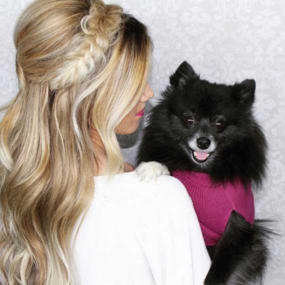Woman holding dog in sweater woman holding dog in sweater